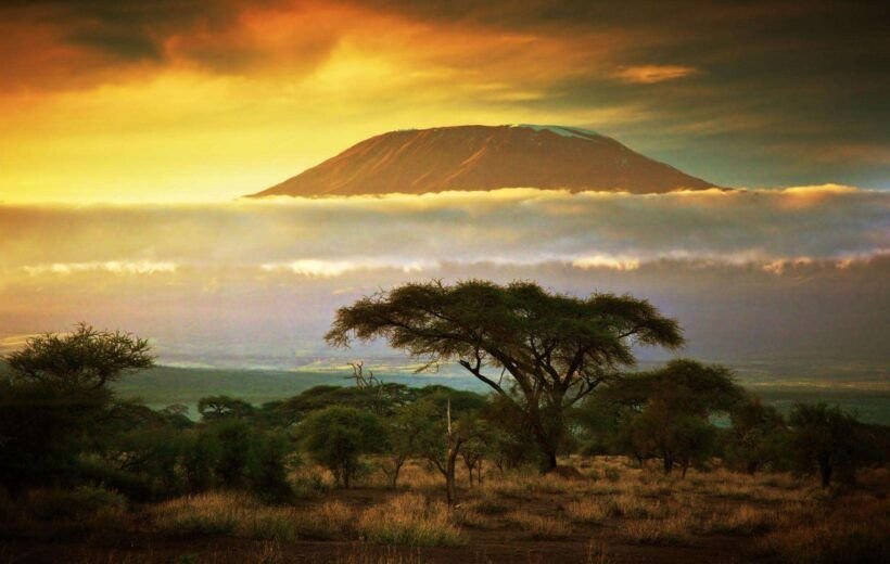 Mount-Kilimanjaro-and clouds-line-at-sunset-view-from-savanna-landscape-in-Amboseli-Kenya-Africa