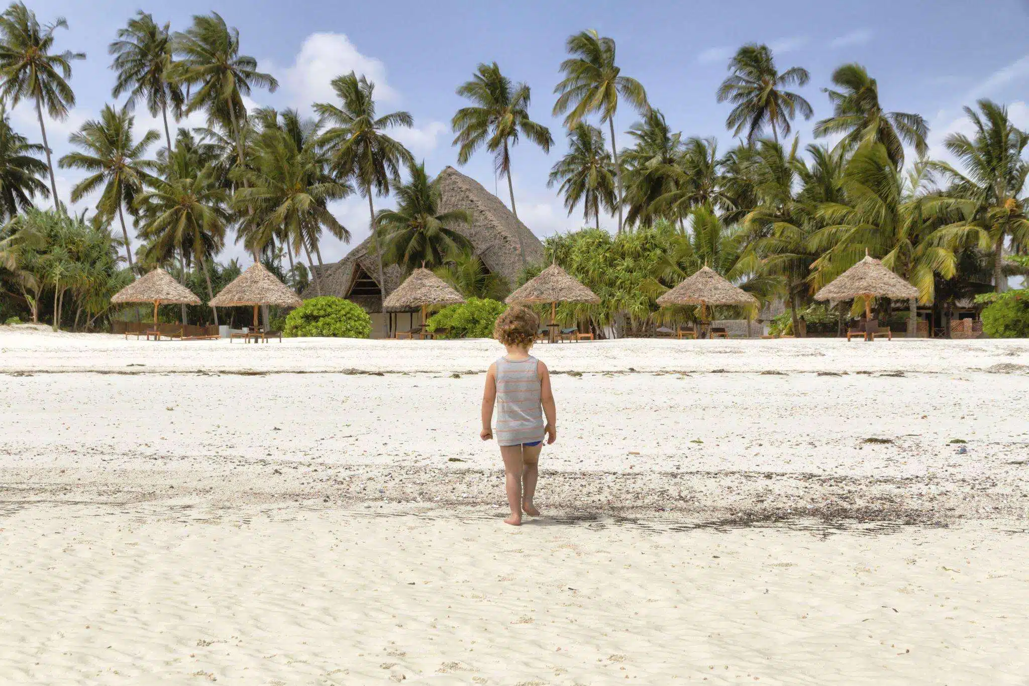 Children walking on the beach in Zanzibar